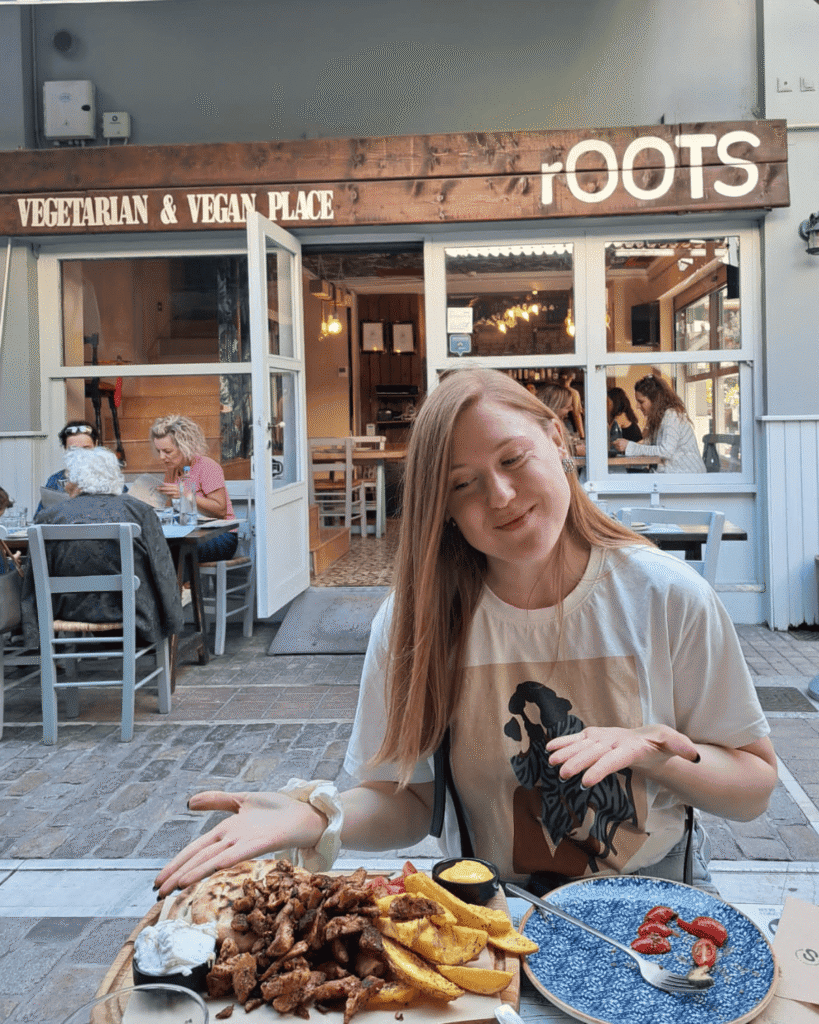 Girl at a vegan restaurant Roots in Solun in Greece looking at a vegan gyros.