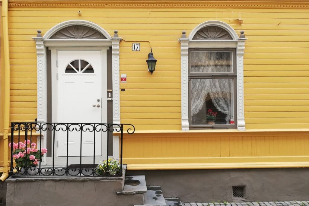 Žuta kuća s bijelim vratima u Trodheimu u Norveškoj.